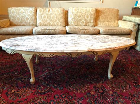 Lot 134 French Provincial Oval Marble Top Coffee Table 60 L X 26 W X