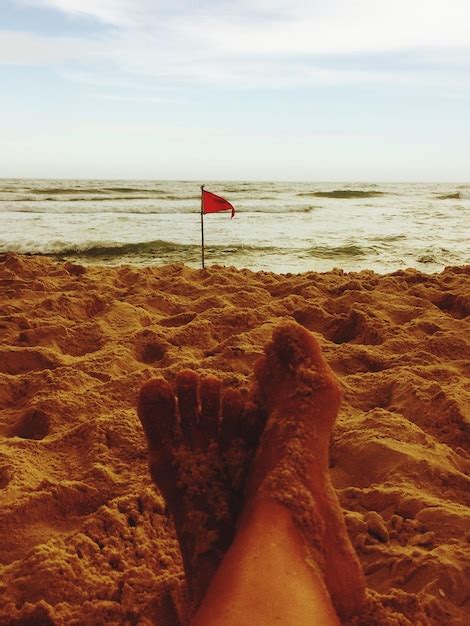 Premium Photo Low Section Of Person At Beach