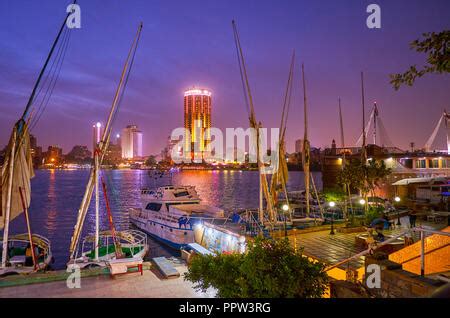 The Illuminated High Rises Of Gezira Island Are Reflected In Dark