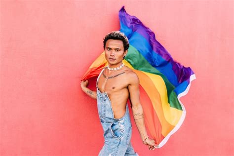 Premium Photo Portrait Of Smiling Gay Man Holding Rainbow Flag