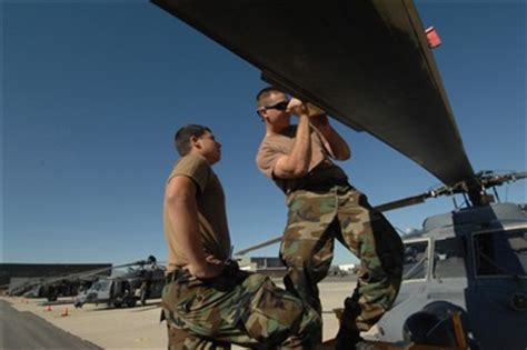 Airmen 1st Class William Jackson And Adam Houff Adjust An Hh 60 Pave