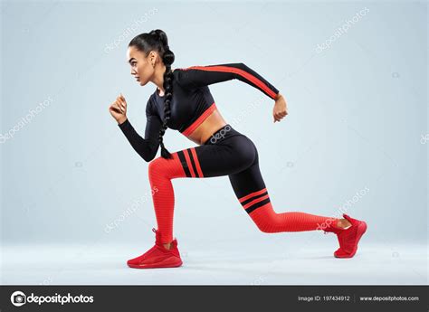 A strong athletic, women sprinter, running wearing in the sportswear, fitness and sport ...