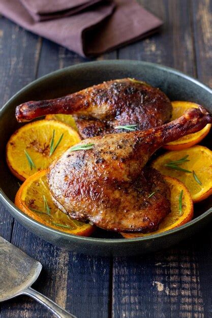 Premium Photo Baked Duck Legs With Oranges And Rosemary Rustic Style