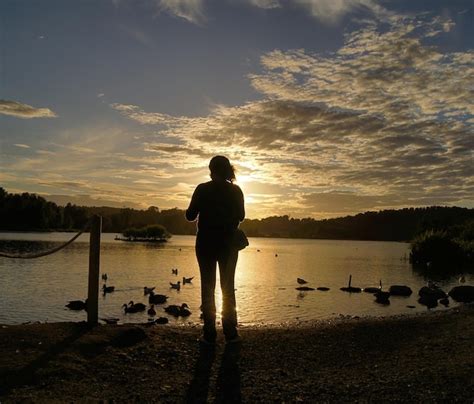 Premium Photo Silhouette Woman Standing At Riverbank Against Sky