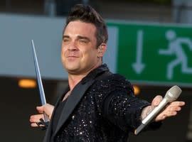 Robbie Williams Signs Saucy Fans Bum During Take Me Home Tour In Sweden