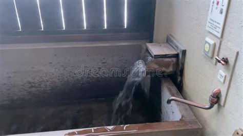 A Private Wooden Outdoor Hot Springs Bath Filling Up With Water In