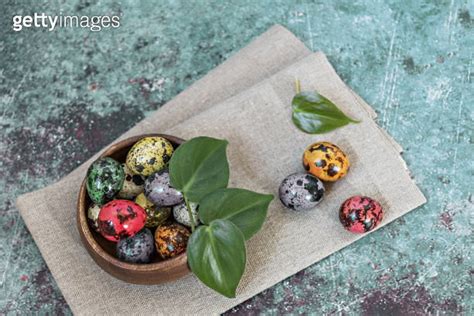 Happy Easter Quail Painted Spotted Eggs In A Wooden Bowl On A Linen