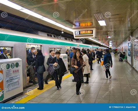 Commuters Leave A Crowded Train On The Busy Subway Underground At A