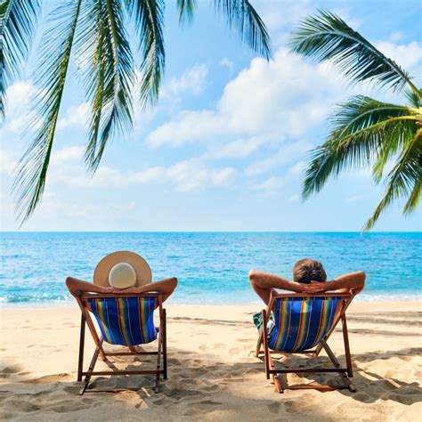 Couple Relax On The Beach Enjoy Beautiful Sea On The Tropical Island