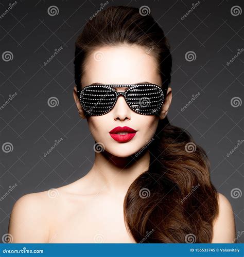 Fashion Portrait Of Woman Wearing Black Sunglasses With Diamonds And Red Lips Stock Image