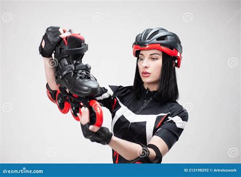 Slender Woman In Sportswear And Helmet With Roller Skates In Her Hands