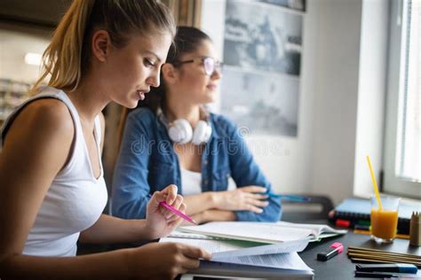 Happy Group Of Friends Studying And Talking Together At University