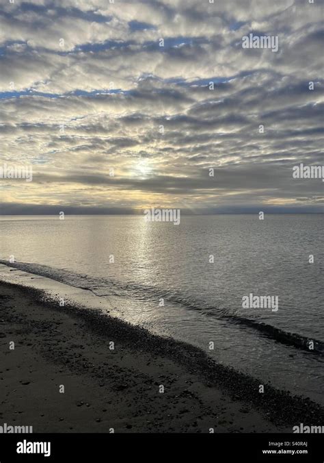 Sun Rays Shining Through Layers Of Clouds Atlantic Ocean And The Beach