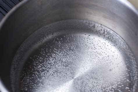 Overhead view of water beginning to boil - Free Stock Image