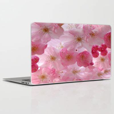 A Laptop Computer With Pink Flowers On The Screen And Its Cover Is Open