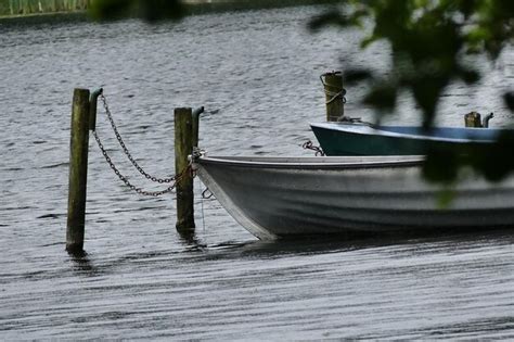 Premium Photo Boat Moored In Lake