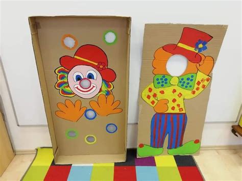 Two Cardboard Boxes With Clowns Painted On Them Sitting Next To Each