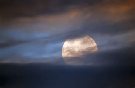 Full moon behind clouds - The News Room