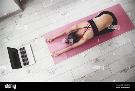 Upper View Photo Of A Caucasian Woman In Sportswear Doing Stretching