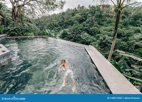 Human Swimming in Bali Infinity Pool Stock Photo - Image of human ...