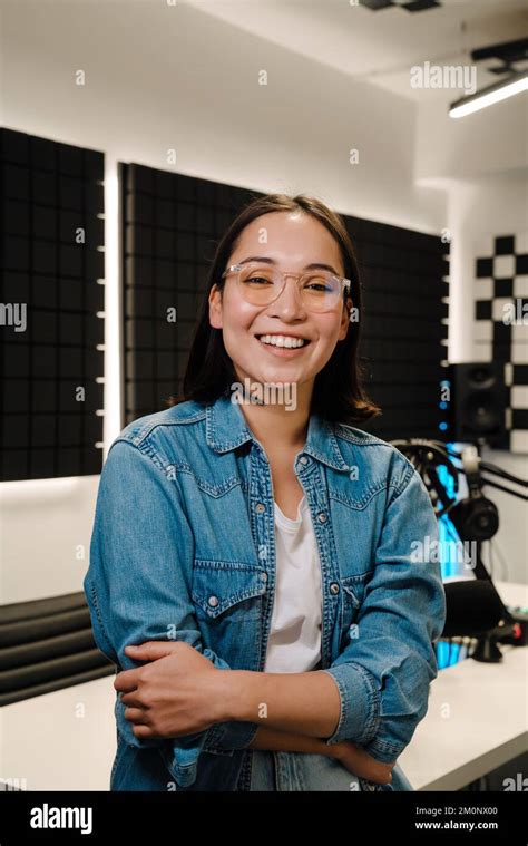 Beautiful Happy Young Female Radio Host Smiling While Broadcasting In