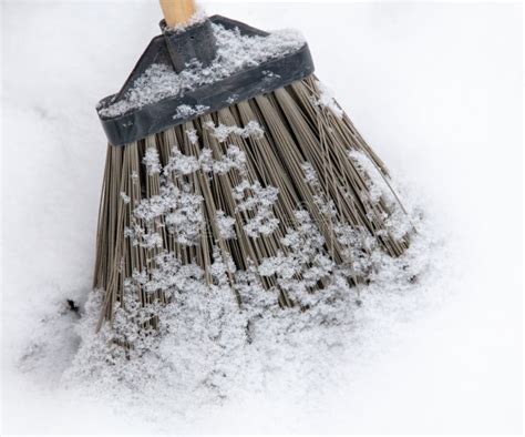 A Broom in the Snow. Snow Removal in Winter. a Broom Sweeps the Snow ...