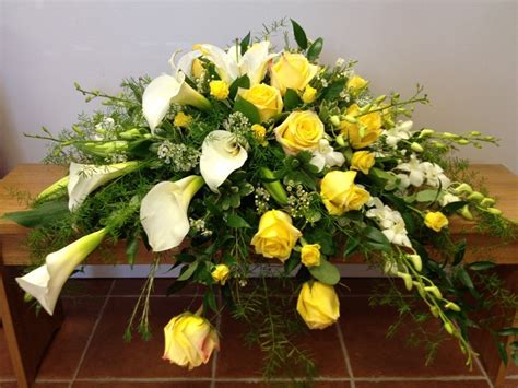 Elegant Calla Lilies Grace This Casket Spray Along With Orchid Sprays