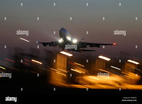 Airliner taking off at night Stock Photo - Alamy