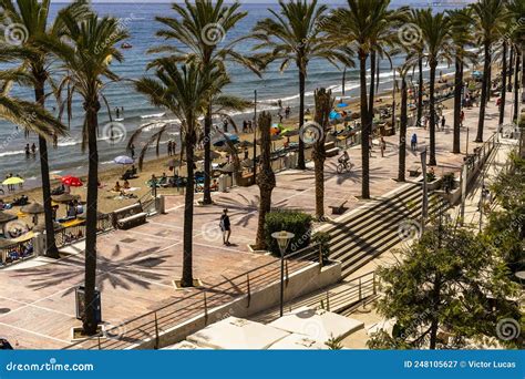 People On The Beach With Palm Trees And Parasols Marbella Costa Del