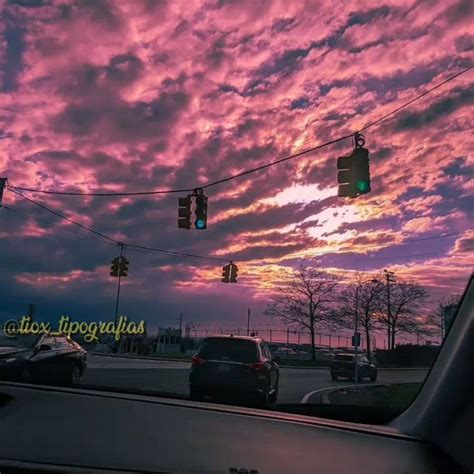 The Sky Is Pink And Purple As Cars Drive By