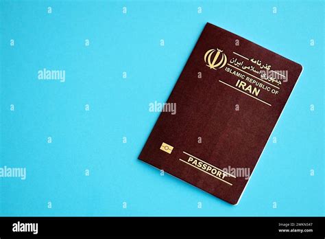 Red Islamic Republic Of Iran Passport On Blue Background Close Up Tourism And Citizenship