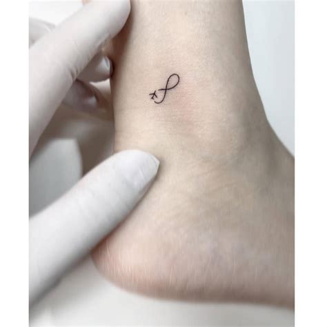 Infinity Symbol And Airplane Tattoo Located On The