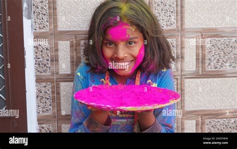 Attractive girl in pink colors Holi. Holi facial shot on spring color ...