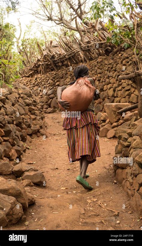 A Traditional Ethiopian Konso Tribe Woman Carrying A Bag On Her Back In