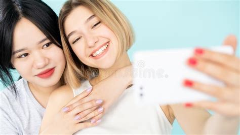 Two Friends With Mobile Phone Taking Selfies Summer Time Stock Photo