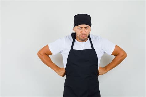 Free Photo Baker Man Standing With Hands On Waist In T Shirt Apron