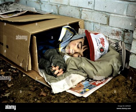 Homeless Boy Sleeping Rough In Street Stock Photo Alamy