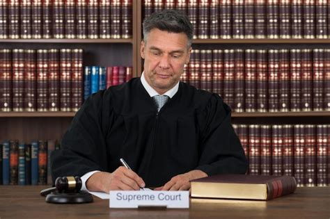 Premium Photo Judge Writing On Paper At Table In Courtroom