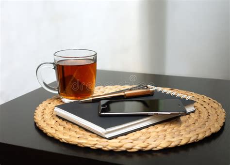 Home Workplace Black Notepad Cup Of Tea Business Pen And Mobile