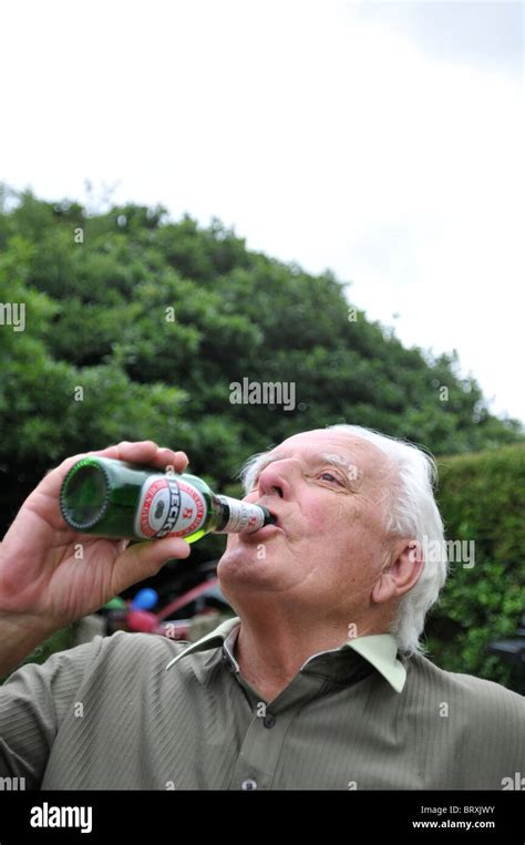 Senior man drinking beer from bottle Stock Photo - Alamy