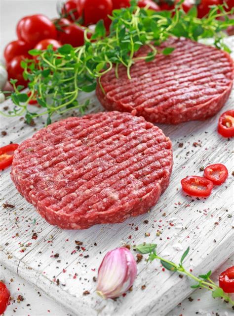 Fresh Raw Beef Round Patties For Making Homemade Burger On Wooden