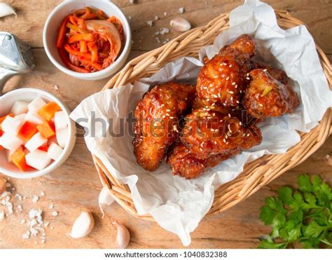 Deep Fried Chicken Wing With Garlic Sauce In Korean Style Serve With Kimchi And Pickled Radish