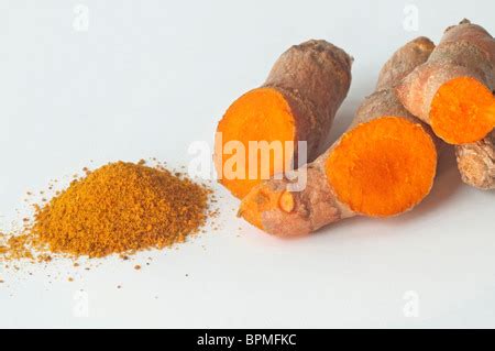 Turmeric Plant With Herb Powder And Roots Growing In Soil Used In Food