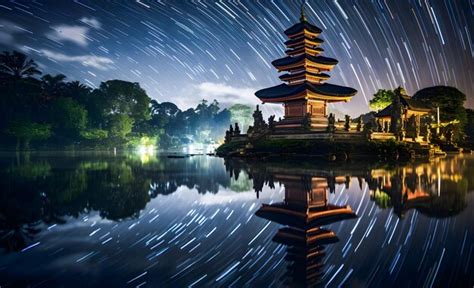 Premium Photo Pura Temple At Night With Starry Sky And Reflection In