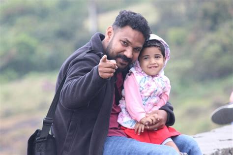 Premium Photo Portrait Of Father With Cute Daughter Sitting Outdoors