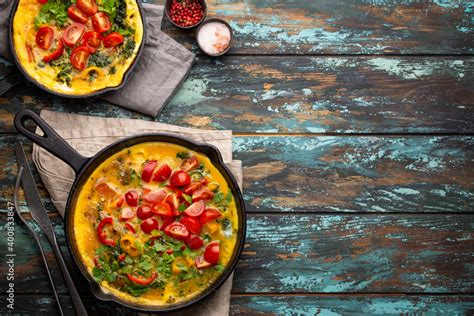 Healthy Frittata In Two Cast Iron Pans With Fried Beaten Eggs And