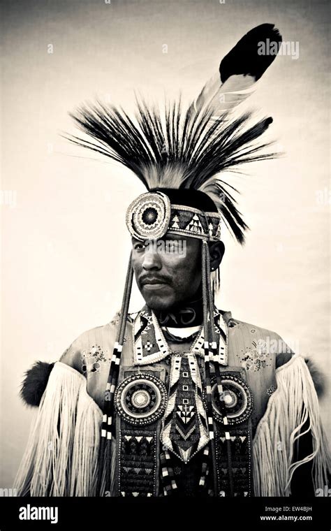 Portrait Of A Native American Man Wearing An Elaborate Feather And Bead