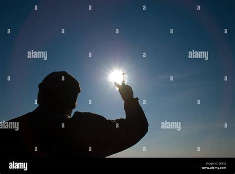 Man Holding A Sun In His Hands Against The Sky Stock Photo Alamy