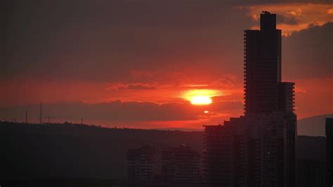 8K Red Sunset Through City Skyscrapers 12263534 Stock Video at Vecteezy