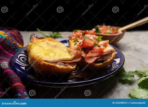 Molletes With Ham Refried Beans And Melted Cheese On A Gray Background